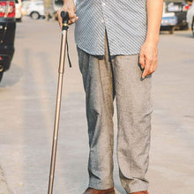 Foldable and adjustable walking cane with sleek T handles, lightweight and portable.