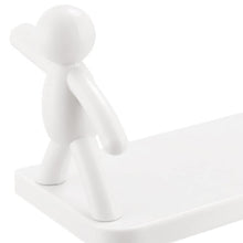 Wall-mounted shelf with human figurine