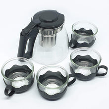 Glass kettle and cup set on a white background